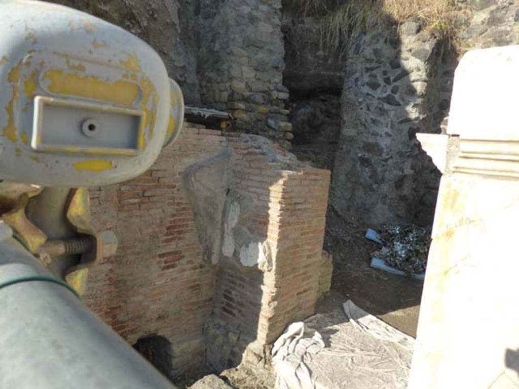 Herculaneum, September 2015. Looking north-west towards west side of the front of the Augusteum, still unexcavated. In this unexcavated area, a second symmetrical arch to the already excavated four-sided arch on the east side, would have been seen.
It is expected to be located opposite the main entrance to the Basilica Noniana.
According to Kraus and von Matt, - West of the arch, the recent excavations have laid bare a row of brick piers which are reinforced by pilasters at the corners and were formerly faced with marble. These supported stuccoed arcades. Like the arch, this elegant construction on grounds of technique and style, can be dated to about 62AD and seems to correspond to what one finds on eighteenth century plans and drawings which located at this spot a five-gated entrance to the so-called Basilica, a building explored by Alcubierre and Weber only though tunnels.
Kraus T. and von Matt L., 1975. Pompeii and Herculaneum: Living cities of the dead. New York: Abrams. (p.120)