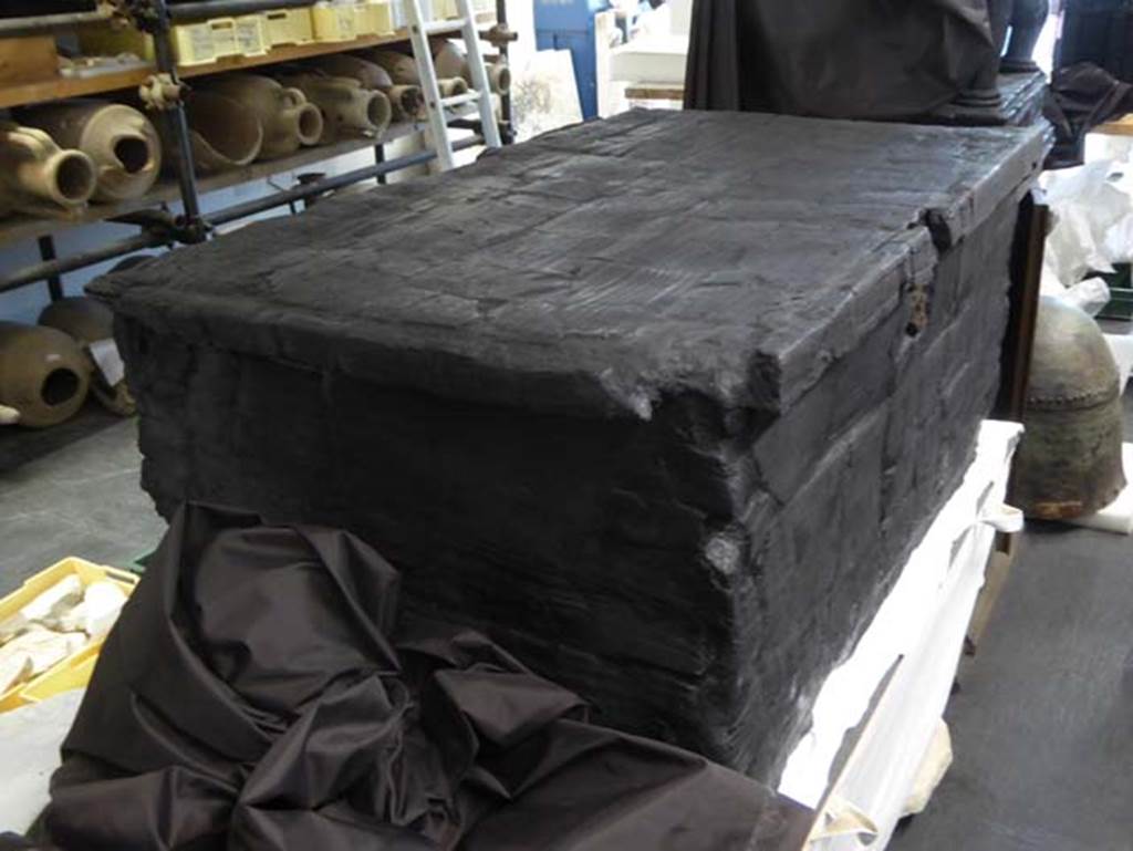 Decumanus Maximus, Herculaneum, September 2016. Carbonised wooden arca/strong box.
Photo courtesy of Michael Binns.
According to De Carolis - this complete example was found in 1961 in the portico of Decumanus Maximus (height 48cm, length 104cm, depth 63cm).
See De Carolis, E. (2007). Il mobile a Pompei ed Ercolano, letti tavoli sedie e armadi. Rome, “L’ERMA” di Bretschneider, (p. 141, fig.106).