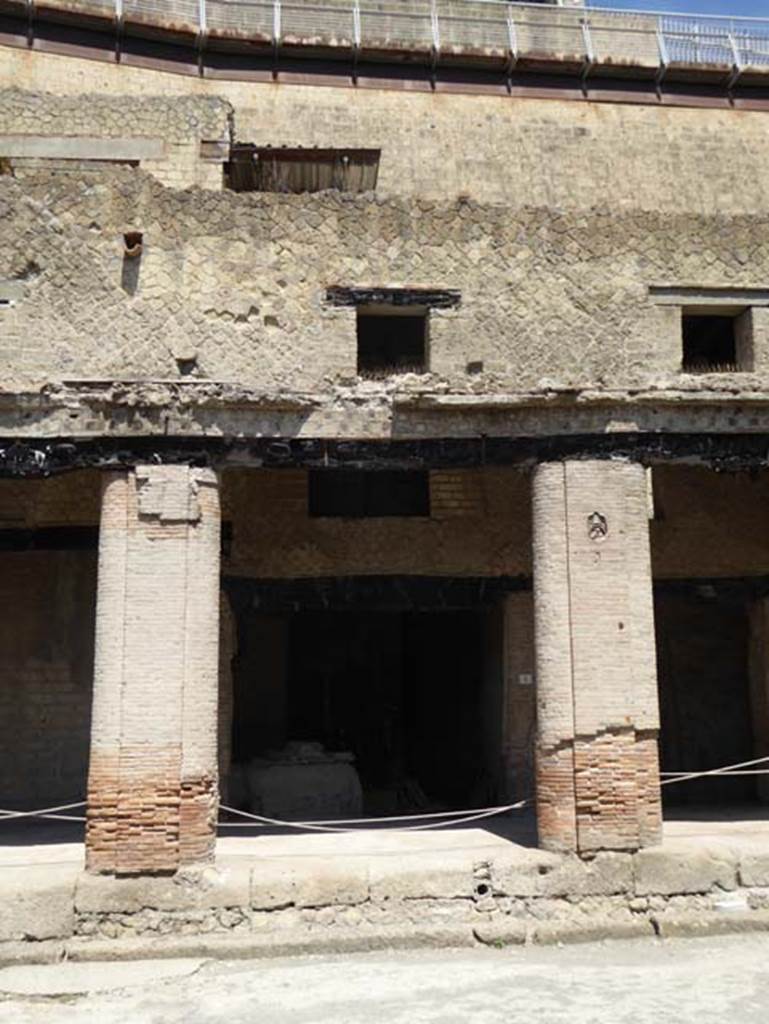 Decumanus Maximus, Herculaneum, July 2015.   Building on north side of the Decumanus Maximus, doorway and upper floors of shop numbered 4. Photo courtesy of Michael Binns.
