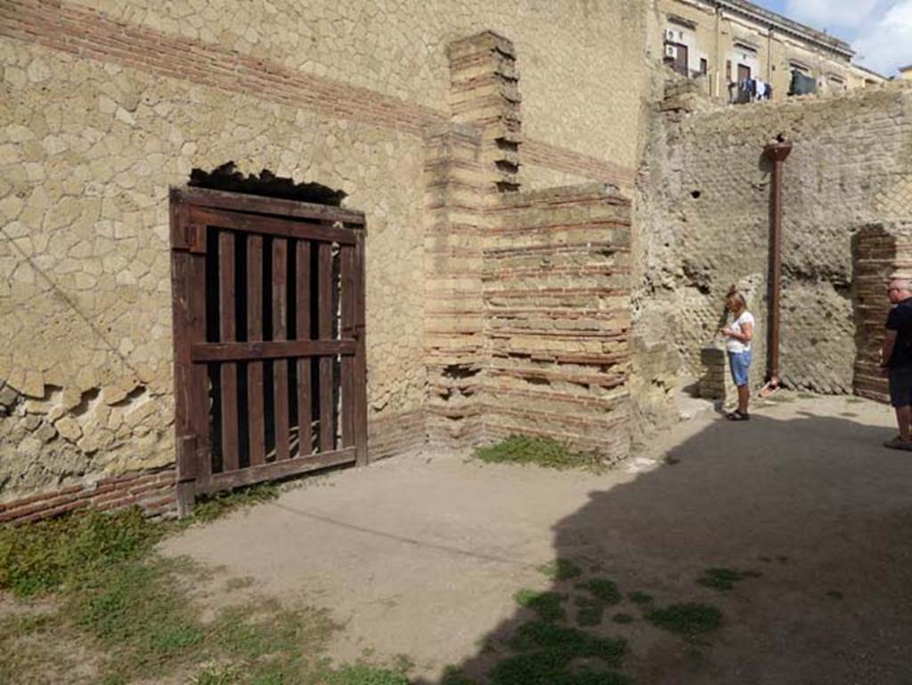 II.1 Herculaneum, October 2014. Rooms on west side of atrium, looking north.
The wooden gate covers a break in the east wall belonging to the large salon of the house at II.2. Photo courtesy of Michael Binns.