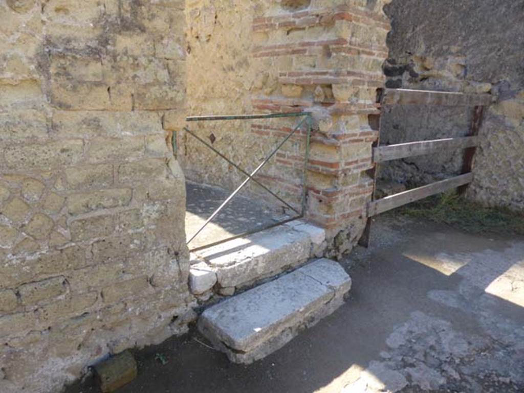 II.1 Herculaneum, September 2015. Two doorways on south-west side of atrium, steps to a corridor, on left.
