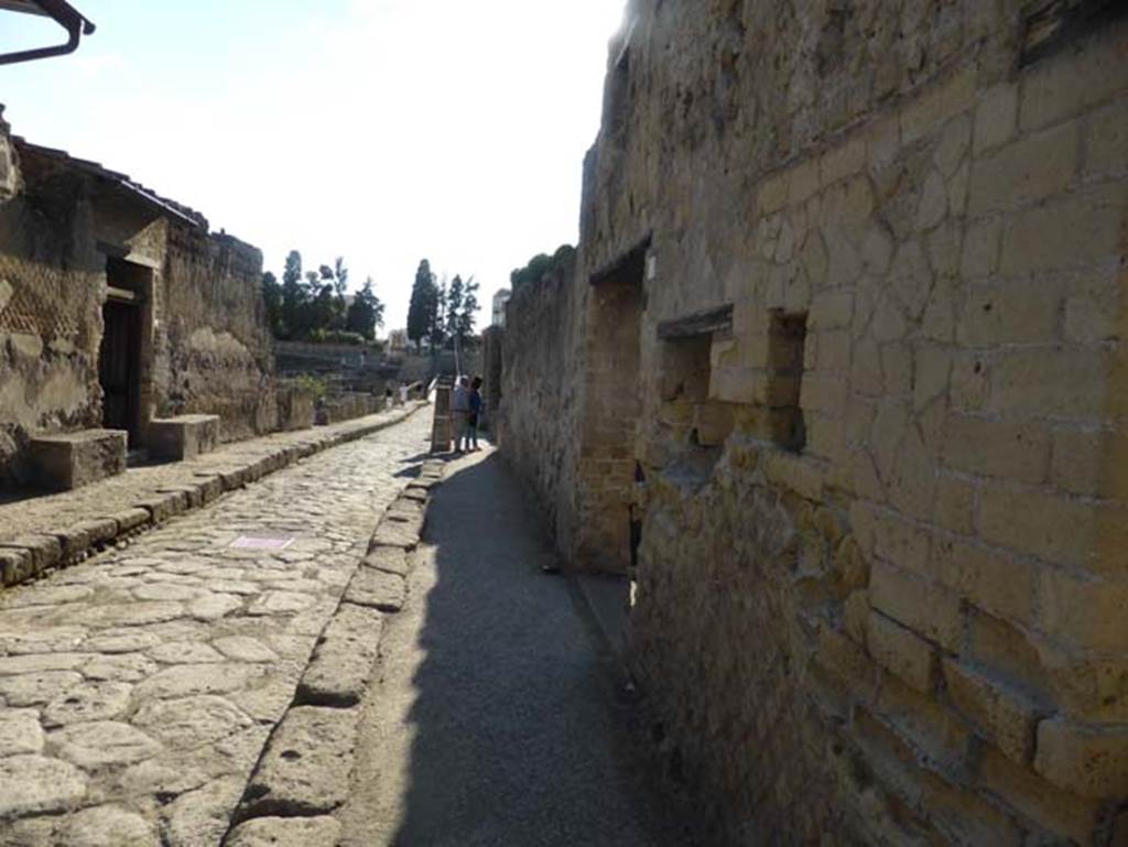 II.4 Herculaneum, on right, September 2015. Looking south along Cardo III Inferiore from near the entrance doorway to the shop. On the left is the entrance doorway to III.3 Casa dello Scheletro.
