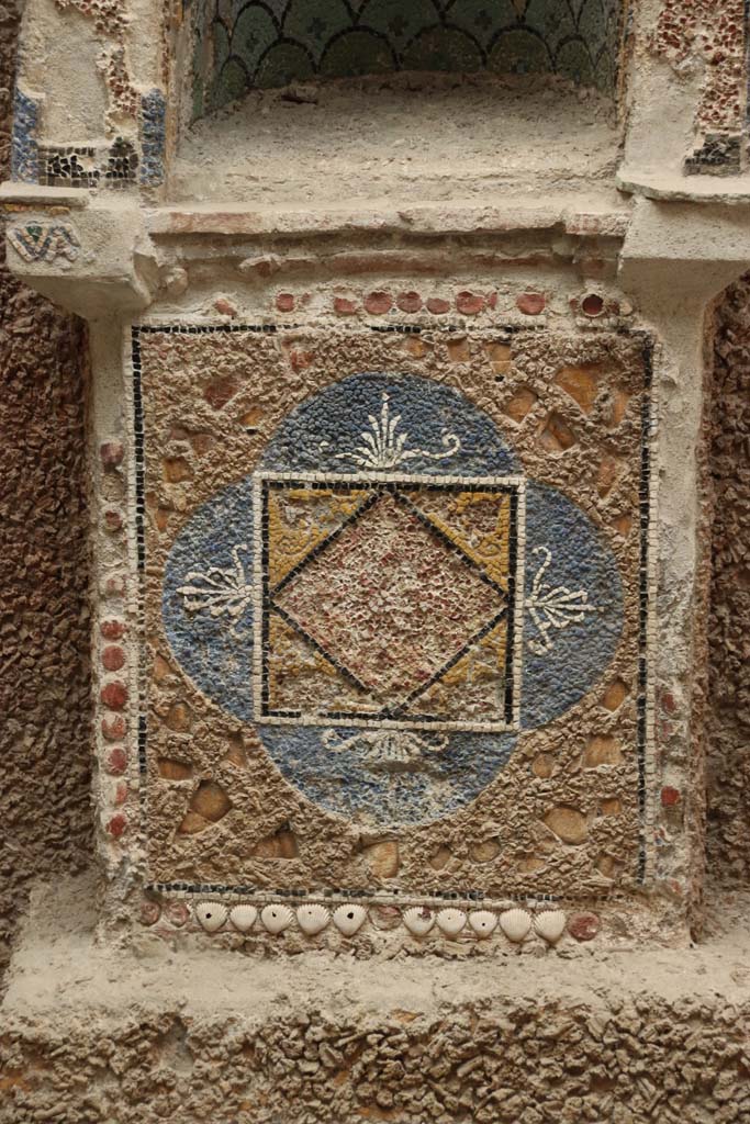 III.3 Herculaneum, September 2019. Detail of base of mosaic and shell-trimmed aedicula. 
Photo courtesy of Klaus Heese.
