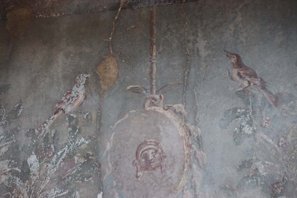 III.3, Herculaneum, September 2017. Detail from upper centre of garden painting on south wall above nymphaeum. 
Photo courtesy of Klaus Heese. 
