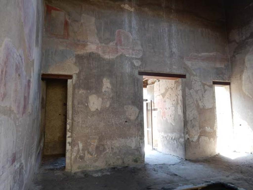III.16, Herculaneum, May 2018. Looking towards east wall of room 9, atrium, with doorway to room 3, on left. 
Photo courtesy of Buzz Ferebee.
