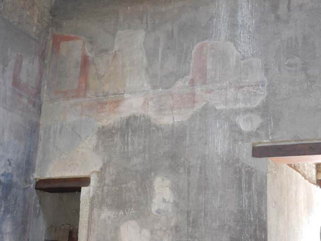 III.16, Herculaneum, May 2018. 
Room 9, east wall of atrium, detail of painted decoration above doorway to room 3, in north-east corner. 
Photo courtesy of Buzz Ferebee
