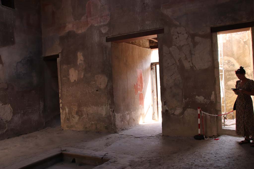 III 16, Herculaneum, September 2019. 
Looking towards east wall of atrium 9, with doorways to room 3, on left, entrance corridor in centre, and room 2, on right.
Photo courtesy of Klaus Heese.

