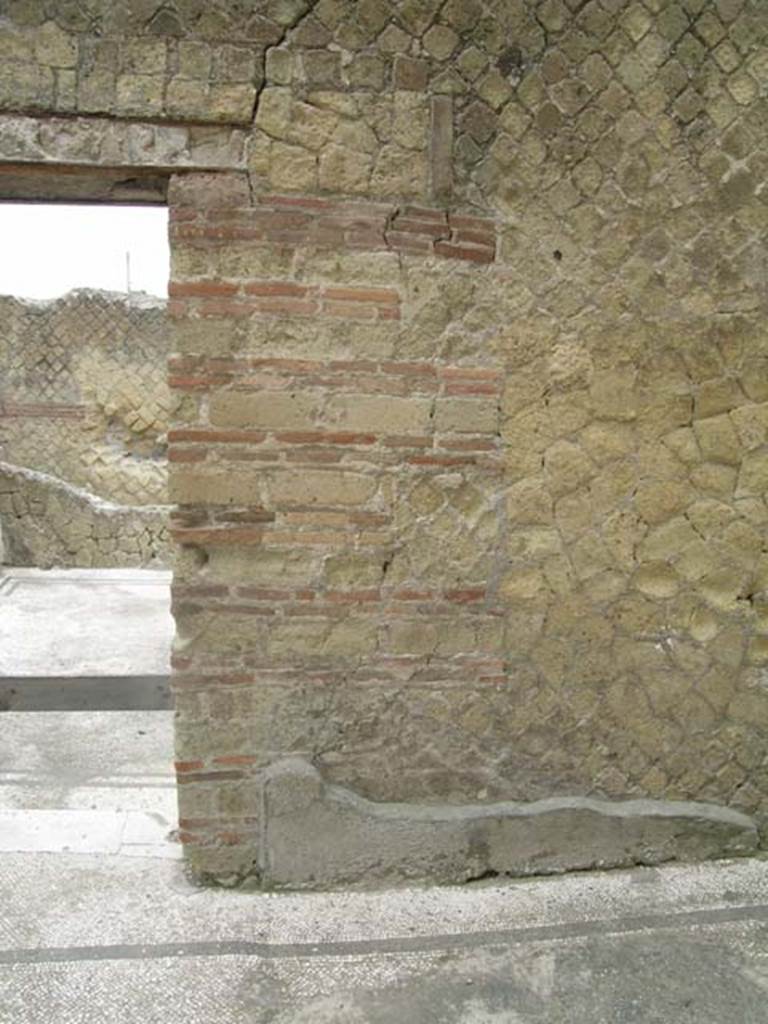 IV.2/1, Herculaneum, June 2005. Looking west towards north side of doorway in room on west side of large triclinium. 
Photo courtesy of Nicolas Monteix
