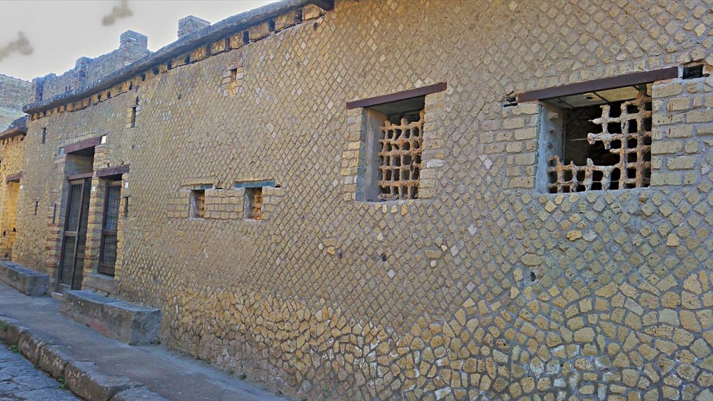 IV.4 and IV.3 Herculaneum, on left, photo taken between October 2014 and November 2019.
Looking north along front façade on east side of Cardo IV.
Above the doorways are the remains of the holes for the support beams of a long overhanging gallery. Photo courtesy of Giuseppe Ciaramella.