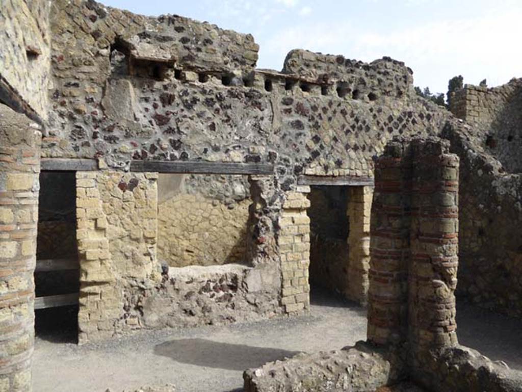 IV.4, Herculaneum, October 2014. Doorway to room 13, on left, and window and doorway into room 14, centre right, taken across courtyard 12. 
Photo courtesy of Michael Binns.
