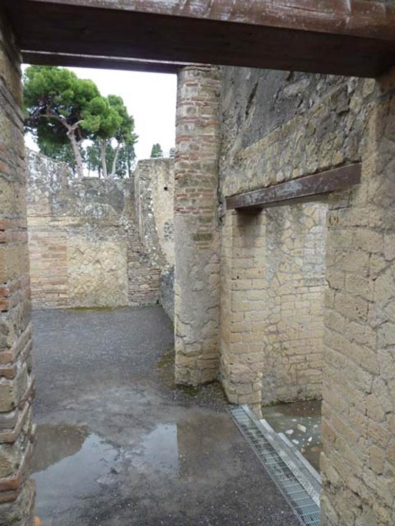 IV.4 Herculaneum. September 2015. Looking east across south end of courtyard 3, towards the south side of open courtyard 6. The doorway, on the right with steps down, leads into the large vestibule 17 and the second part of the house.


