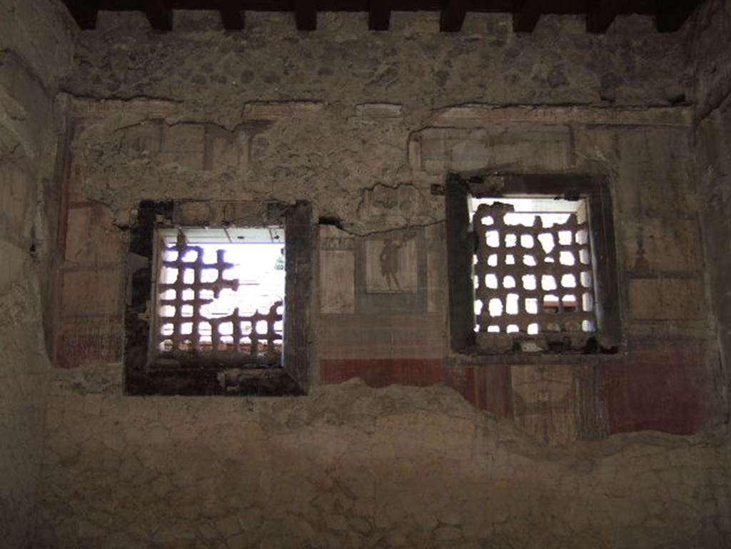 IV.4 Herculaneum. May 2006.  Room 19, two windows in west wall, with iron gratings and part of the wooden frame of the window.
