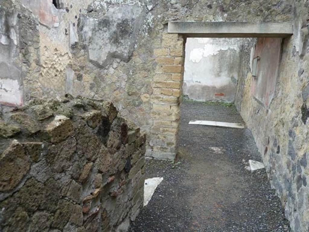 Ins. IV.8, Herculaneum, September 2015. On the left, the doorway into second room on north side of corridor. The other doorway leads to the room at rear and the courtyard area.