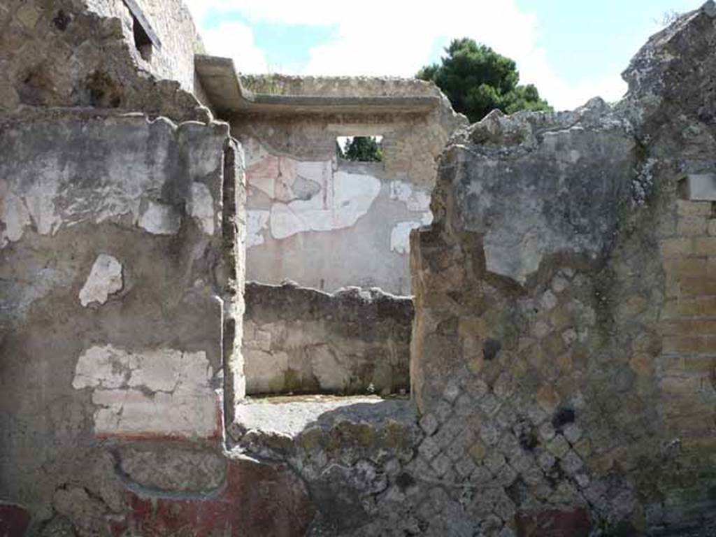 Ins. IV.8, Herculaneum, May 2010. Looking through window in east wall across courtyard.