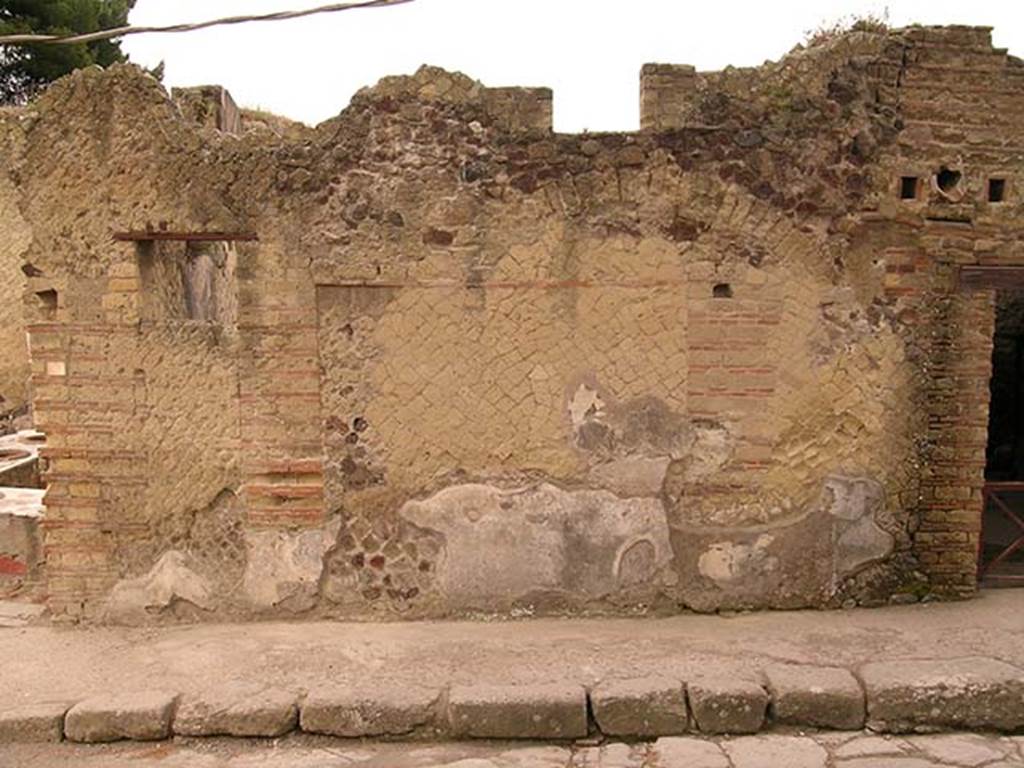 Decumanus Inferiore, south side, Herculaneum. May 2005. Exterior faade between IV.15, on left, and IV.14, on right.
Photo courtesy of Nicolas Monteix.
