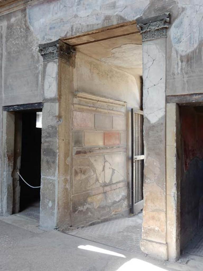 V.1 Herculaneum, May 2018. West side of atrium, with doorway to room 3, on left.
The entrance corridor is in the centre, and doorway to room 2, on right. Photo courtesy of Buzz Ferebee.
