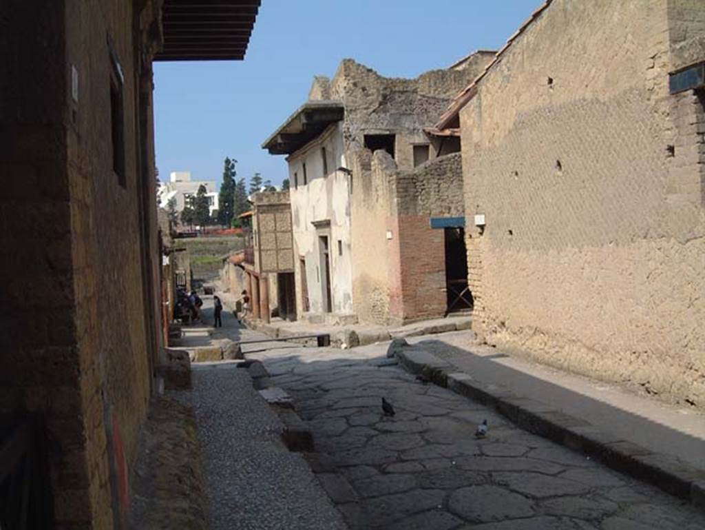 V.2 and V.1 Herculaneum, on east side of Cardo IV Superiore. May 2001. 
Looking south from outside doorway of V.2, towards junction with Decumanus Inferiore. Photo courtesy of Current Archaeology. 
