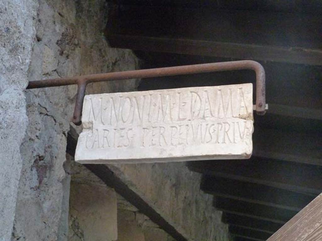 V. 4, Herculaneum, September 2015. Marble plaque marking the property boundary of M. NONI M. L. DAMA.
This north side of this boundary marker would be the property at V.5, Casa del Mobilio carbonizzato or House of the Wooden Furniture. According to Wallace-Hadrill, a reconstructed marble plaque has been hung from an iron fixing on the façade of these properties at the boundary point. On one side JULIA, on the other M(arcus) NONIUS M(arci) l(ibertus) DAMA……
We cannot reconstruct what it was that made Nonius Dama and Julia argue over their boundary, but at least it reveals the identity of the owners on the two sides, a freedman belonging to the biggest family in town, and a woman whose imperial name implies that she too was from a family of imperial freedmen. Who owned which side (and if the plaque has been put back in the right position), we cannot tell.
See Wallace-Hadrill, A. (2011). Herculaneum, Past and Future. London, Frances Lincoln Ltd., (p.215).