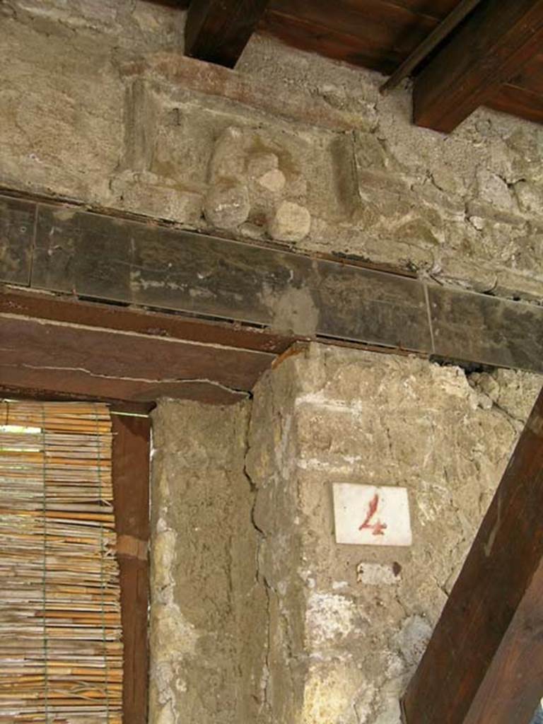 V.4, Herculaneum, May 2005. Detail of upper doorway and plaque above doorway.
Photo courtesy of Nicolas Monteix.