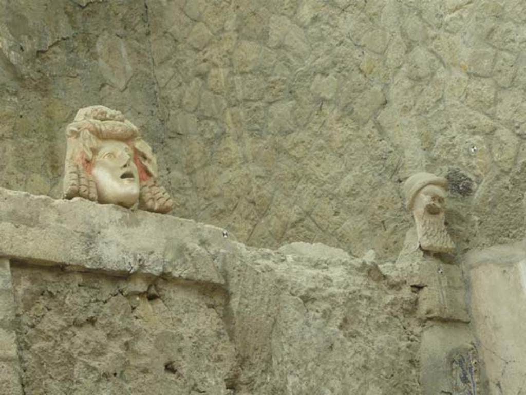V.7, Herculaneum. May 2009. North wall of internal courtyard with theatrical masks. 
Photo courtesy of Buzz Ferebee.
