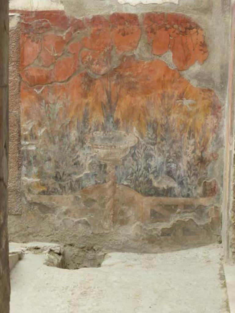 V 7, Herculaneum, June 2014. South-east corner of internal courtyard with garden painting with fountain on east wall.  Photo courtesy of Michael Binns.
