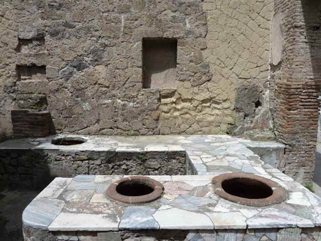 V. 10, Herculaneum, May 2010. Marble-top to counter with inset dolia.