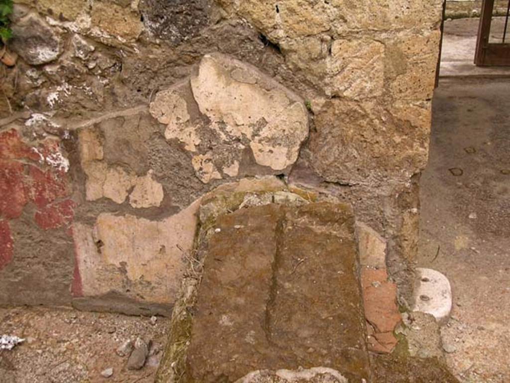 V.11, Herculaneum. May 2005. Base of steps against north wall of atrium, on west side of entrance corridor.
Photo courtesy of Nicolas Monteix.