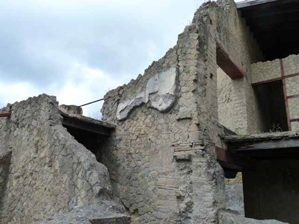 V 21, Herculaneum, May 2010. Looking towards west wall with remains of plaster, above small room in south-west corner.