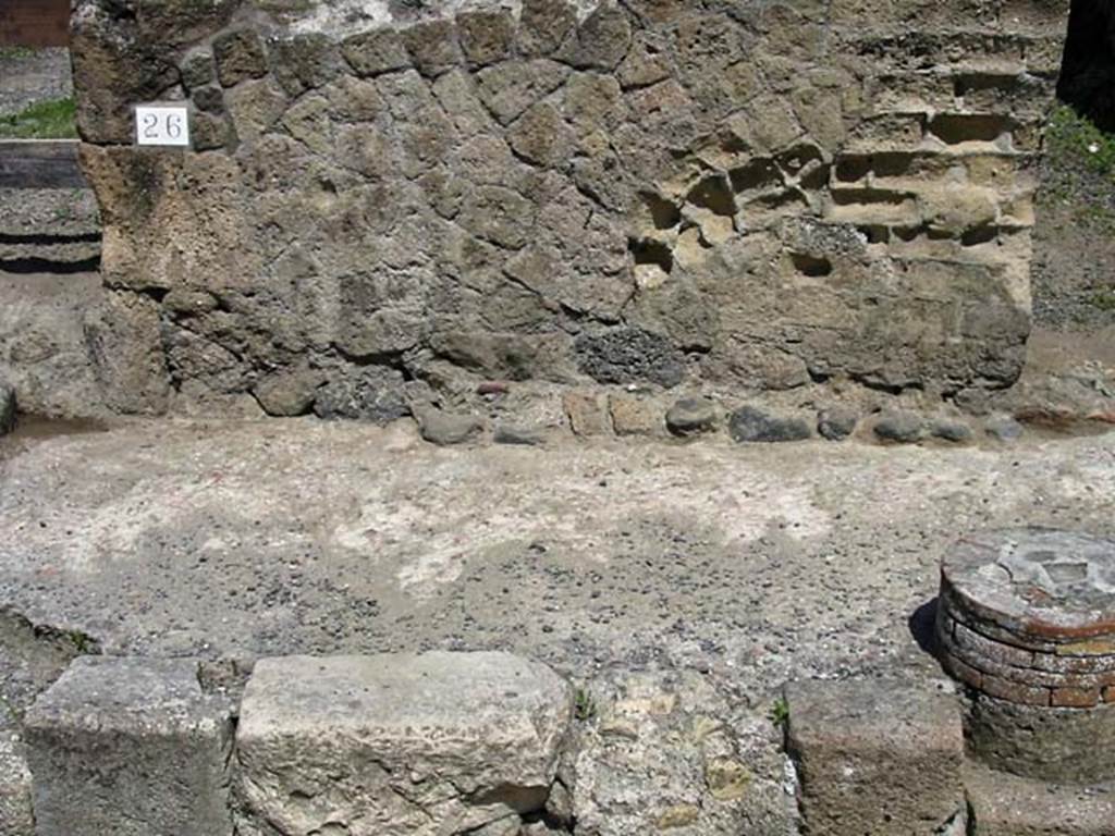 V.26, Herculaneum. May 2003. Facade and pavement on north side of entrance doorway, with V.25, on right. 
Photo courtesy of Nicolas Monteix.

