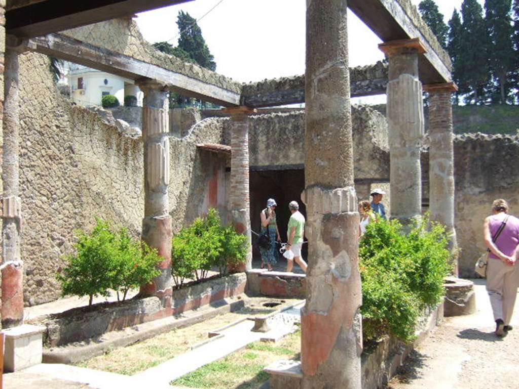 V. 30 Herculaneum, May 2006. Looking east. According to Jashemski, inserted in the low wall, on the right, was the ancient well which had been in this house from its earliest days. See Jashemski, W. F., 1993. The Gardens of Pompeii, Volume II: Appendices. New York: Caratzas. (p.270)