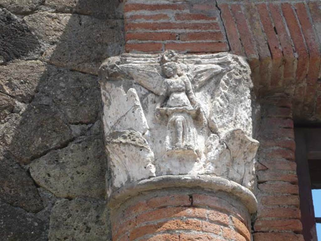 V,35 Herculaneum. August 2013. Detail of Corinthian capitals adorned with winged Victories set in the half brick columns. Photo courtesy of Buzz Ferebee.