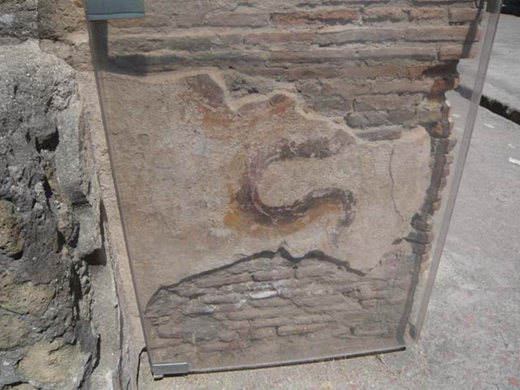 VI 12, Herculaneum, August 2013. Remains of painted serpent on street shrine on north-east corner of Insula VI, adjacent to the shop at VI.12. Looking west. Photo courtesy of Buzz Ferebee. See also Ins. V.9.