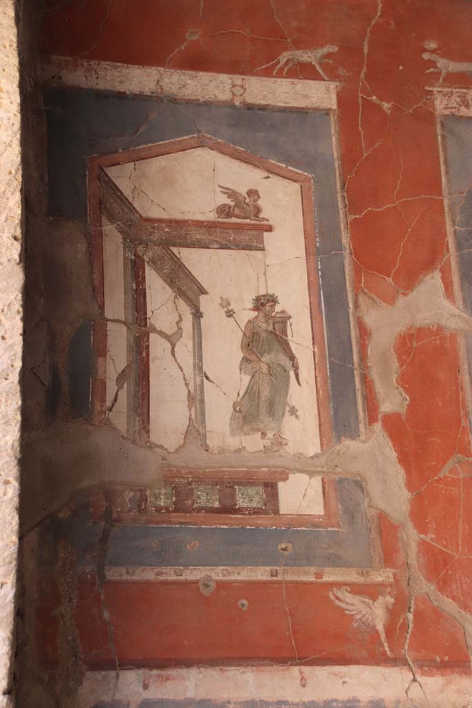 VI.16 Herculaneum. September 2021.
Upper painting at north end of east wall showing a statue of a maenad holding a cornucopia.
Photo courtesy of Klaus Heese.