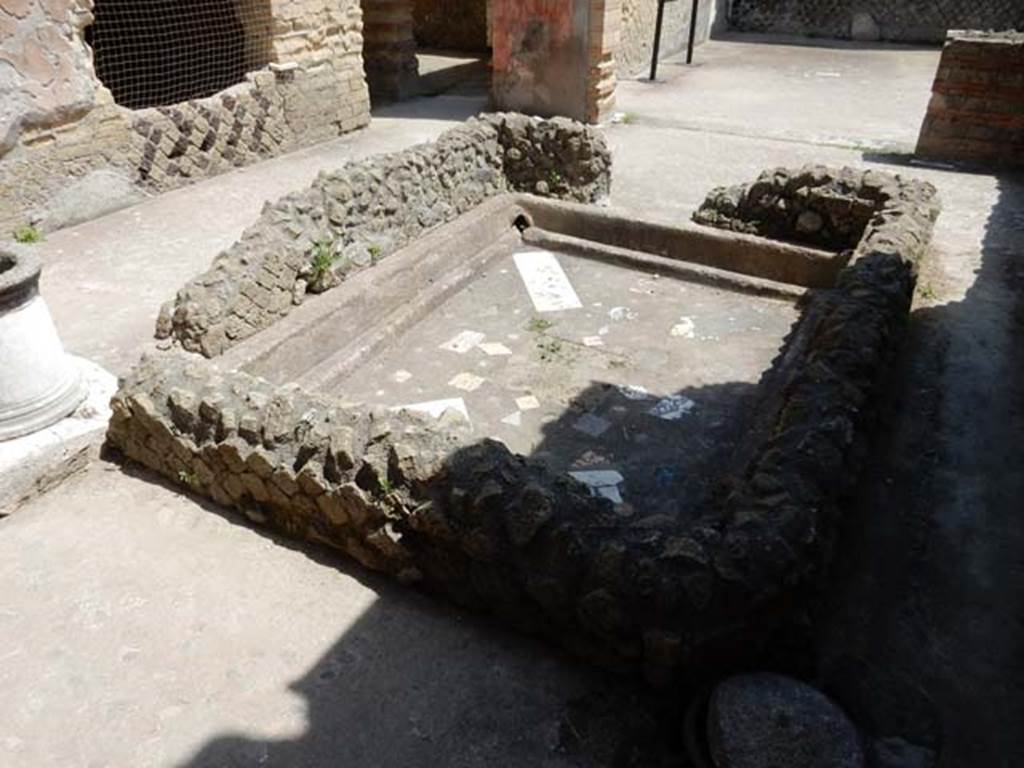 VI.29 Herculaneum. May 2018. Atrium 9, the second atrium, looking north-east across impluvium. 
On the left is the north wall of atrium 9, with window into Room 7. Photo courtesy of Buzz Ferebee.
