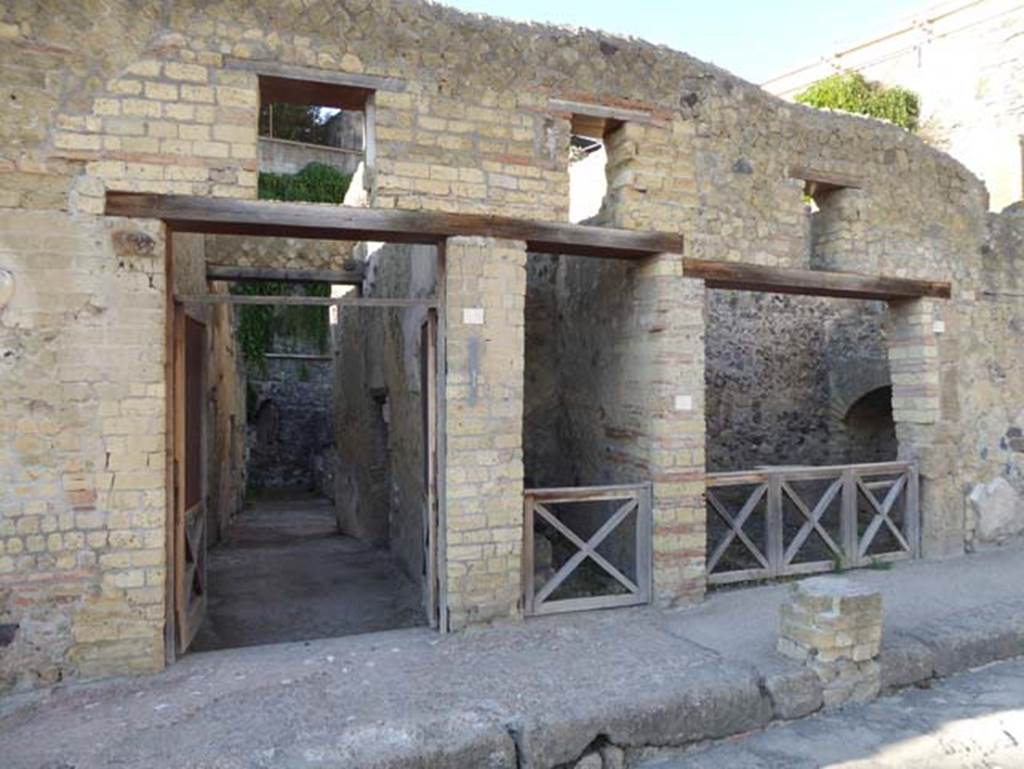VII, 2, on left, VII.3, in centre, VII.4, on right, Herculaneum. September 2015. Entrance doorways.  Photo courtesy of Michael Binns.
