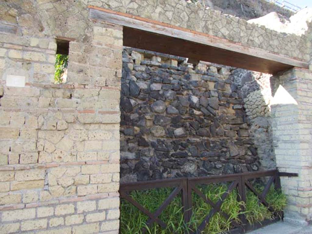 VII.7, Herculaneum, September 2015. Wide entrance doorway on west side of Cardo III, with wall at rear holding back unexcavated.  Photo courtesy of Michael Binns.
