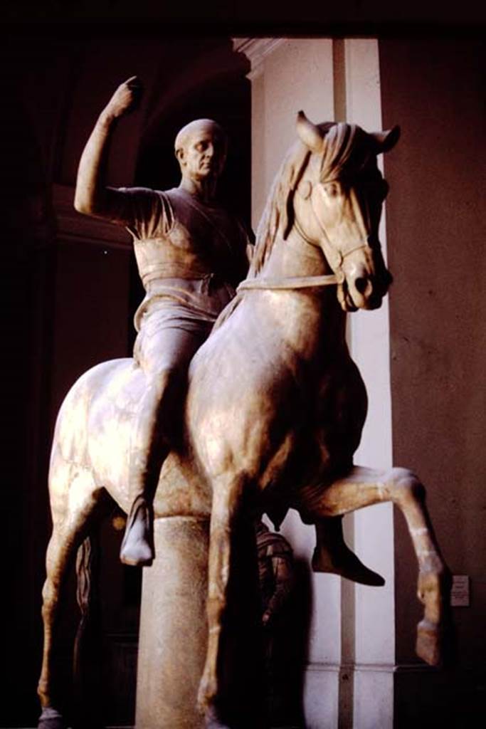 VII.16 Herculaneum. 1978. Statue of M. Nonius Balbus,
Now in Naples Archaeological Museum. Inventory number 6211.
This statue is often identified as the father of M. Nonius Balbus.
The two statues on horseback may be of the same M. Nonius Balbus, but portraying different stages in his life, see Cooley, above, writing below first photo –
See Cooley, A. and M.G.L., 2014. Pompeii and Herculaneum: A Sourcebook. London: Routledge, (p.186-191, F94-105)
Photo by Stanley A. Jashemski.
Source: The Wilhelmina and Stanley A. Jashemski archive in the University of Maryland Library, Special Collections (See collection page) and made available under the Creative Commons Attribution-Non Commercial License v.4. See Licence and use details.
J78f0441
According to Wallace-Hadrill, this statue is often thought of as being from the so-called Basilica but in fact was from outside the theatre.
See Wallace-Hadrill, A. 2011. Herculaneum, Past and Future. London, Frances Lincoln Ltd, (p.192).
According to the information board in the Palazzo Reale at Portici in 2015, the two statues are believed to portray the same individual, being honoured respectively, by the towns of Nuceria and Herculaneum.