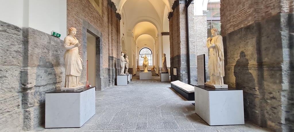 Herculaneum. April 2023. 
Looking along gallery with white marble statues from “Campania Romana” display. Photo courtesy of Giuseppe Ciaramella.
