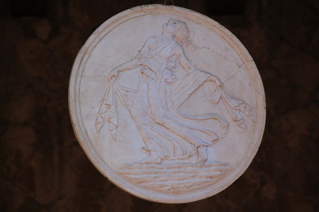 Ins. Orientalis I, 2, Herculaneum, April 2014. Plaster cast of an original marble oscillum disc showing a dancing Maenad, found here.
Photo courtesy of Klaus Heese.
