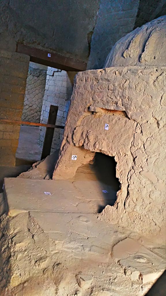 Ins.Or.II.8, Herculaneum, photo taken between October 2014 and November 2019. 
Oven with two stucco phalli in roof above doorway. Photo courtesy of Giuseppe Ciaramella.

