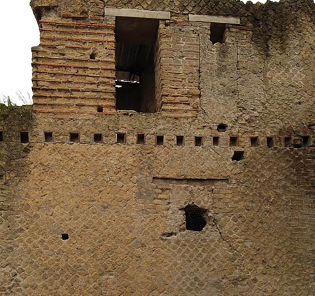 A large brick building with a clock tower
Description generated with high confidence