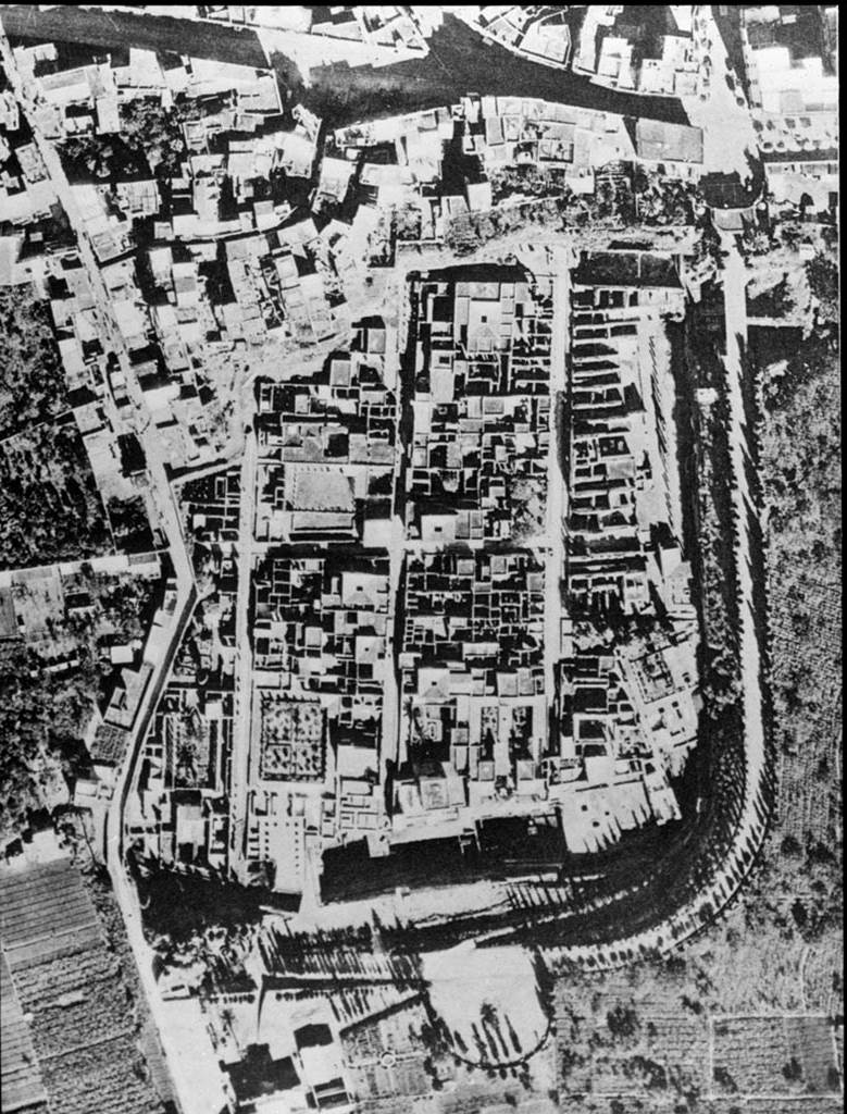 Herculaneum from the air. 1958. Maiuri, 1958 Ercolano, I,p.19.f 22 oM.
At the top of the photo, northern end, are the houses of Resina, now known as Ercolano.
Photo used with the permission of the Institute of Archaeology, University of Oxford. File name instarchbx116im006 Resource ID 42234. 
See photo on University of Oxford HEIR database  

