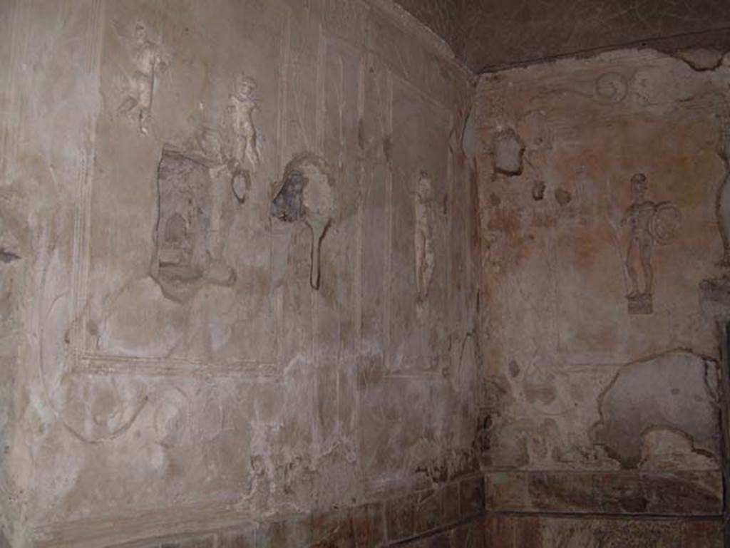 Suburban Baths, Herculaneum, May 2001. Tepidarium, with decorative stucco warriors on white stucco panels set into the walls.  Photo courtesy of Current Archaeology.
