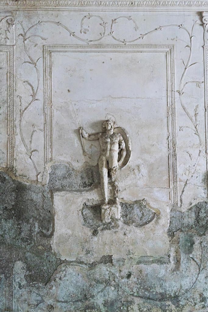 Herculaneum Suburban Baths. October 2023. 
Tepidarium, stucco panel with warrior from north end of east wall. Photo courtesy of Johannes Eber. 
