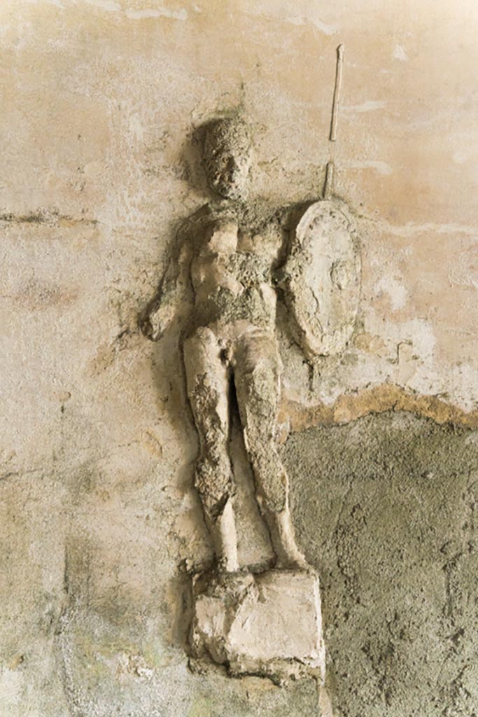 Herculaneum Suburban Baths. October 2023. 
Tepidarium, detail of stucco warrior from centre of east wall. Photo courtesy of Johannes Eber. 
