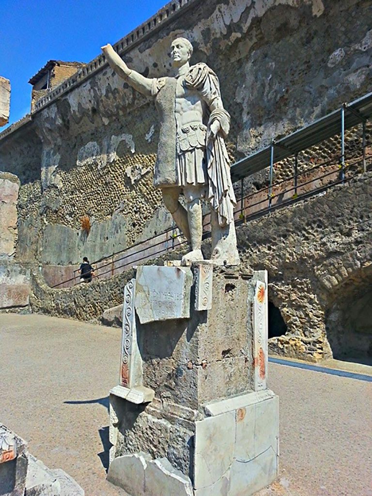 Herculaneum, photo taken between October 2014 and November 2019. 
Statue of Marcus Nonius Balbus. Photo courtesy of Giuseppe Ciaramella.
Parts of the marble statue (its head, left foot and part of the base) were found in 1942 on the terrace outside the Baths, but the left side of the statue’s body and other fragments were only discovered in 1981 on the beach underneath the terrace.
See Cooley, A. and M.G.L., 2014. Pompeii and Herculaneum: A Sourcebook. London: Routledge, F105b, p. 191.
