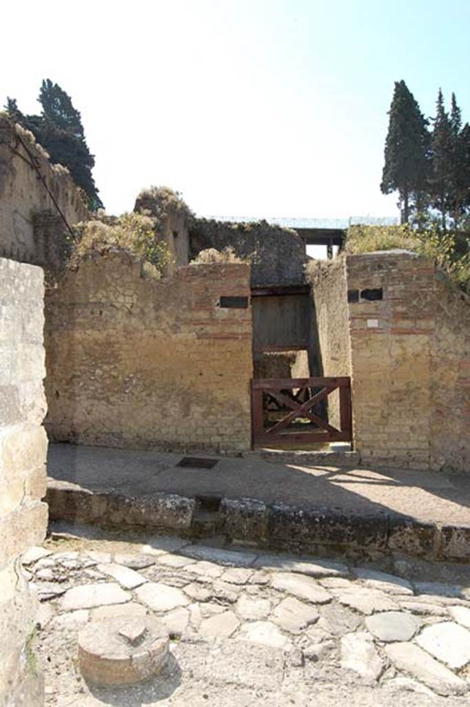 Cardo V, Herculaneum. May 2011. 
Looking east across roadway with remains of a column in pavement, to support a portico outside of V.30
Looking towards doorway at Ins. Orientalis II.15. Photo courtesy of Nicolas Monteix.

