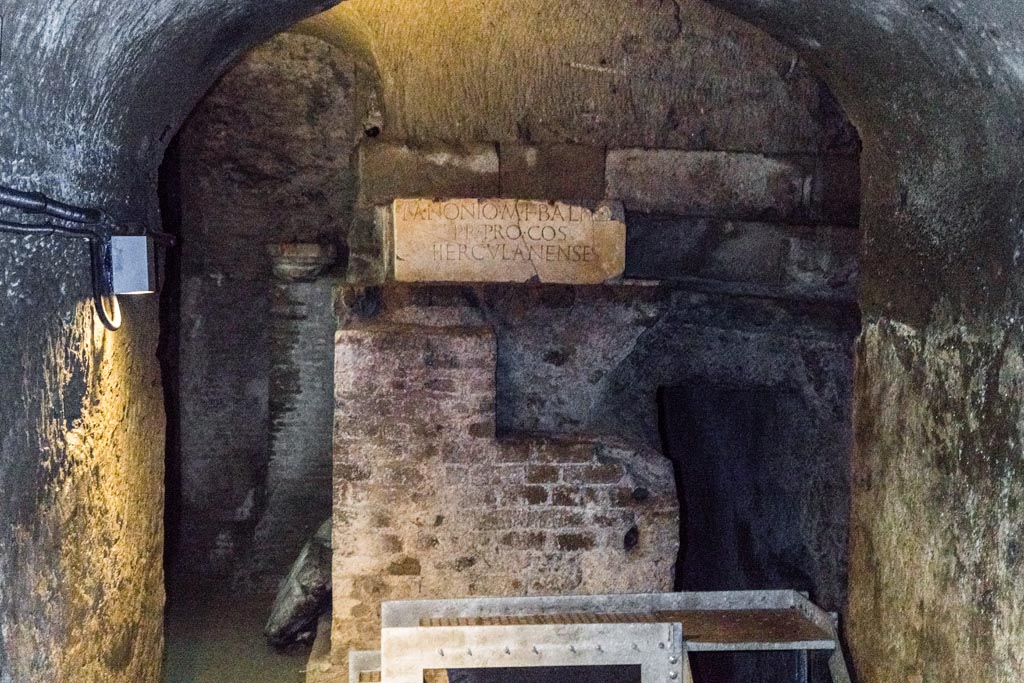 Herculaneum Theatre. October 2023. Looking towards base with honorary inscription to M NONIO M F BALBO at east end of proscenium. Photo courtesy of Johannes Eber.