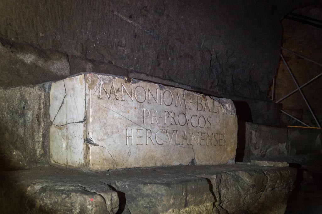 Herculaneum Theatre. October 2023. Marble base with copy of inscription to M. Nonio M F Balbo, in situ underground. Photo courtesy of Johannes Eber.