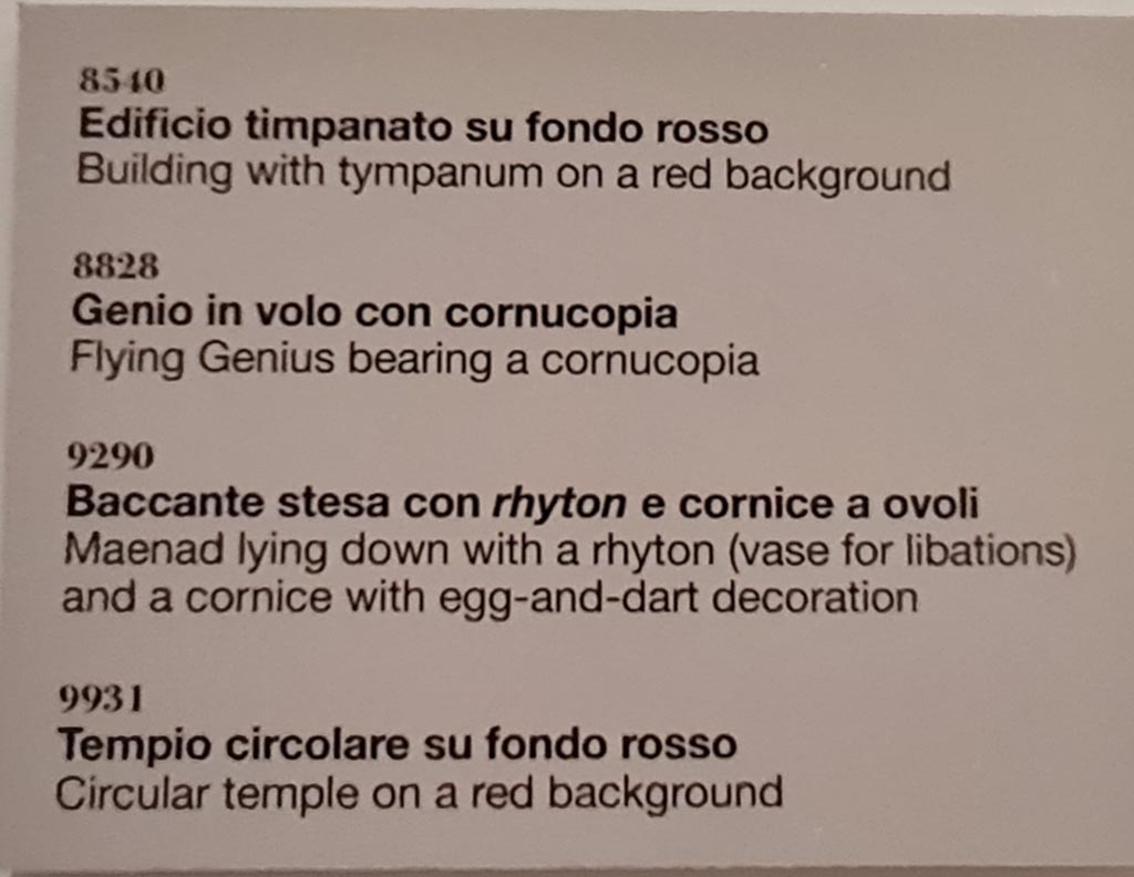 Herculaneum Augusteum. April 2023. Descriptive card of four paintings on wall to left of Arch. Photo courtesy of Giuseppe Ciaramella.